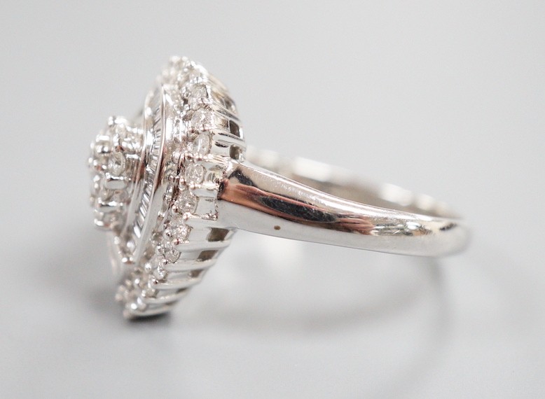 A modern 14ct white gold, baguette and round cut diamond cluster set pear shaped dress ring, size R/S, gross weight 6.7 grams